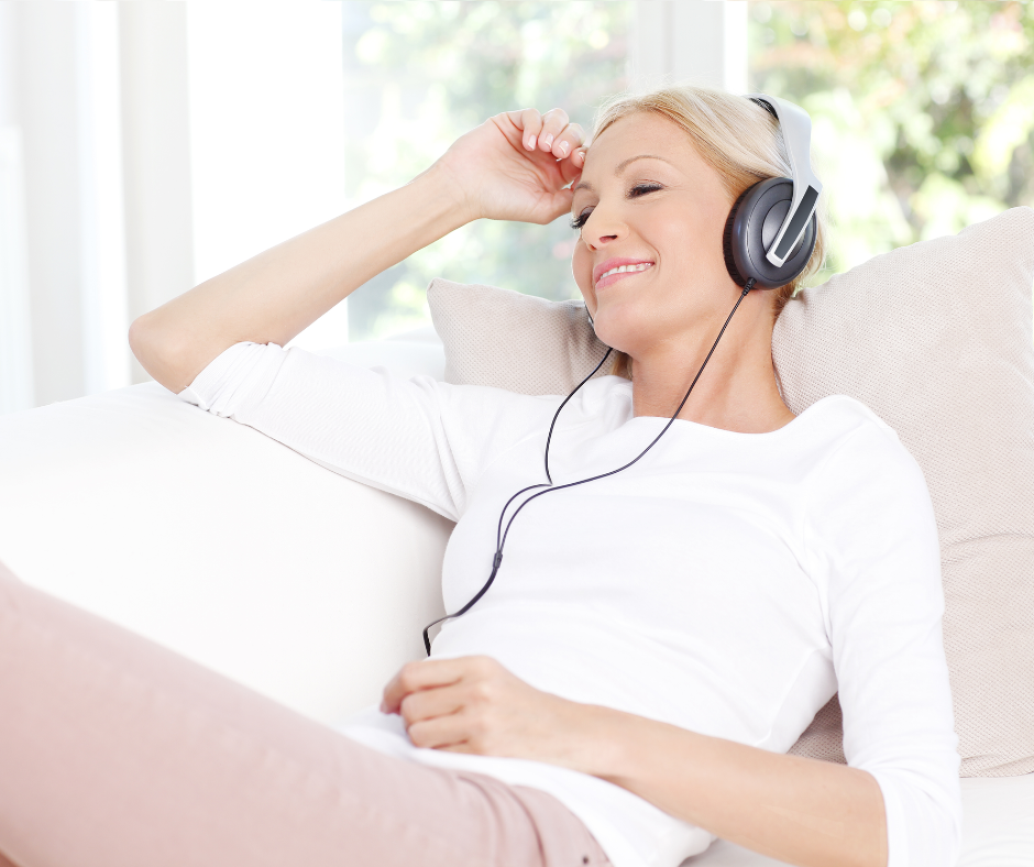Woman with headphones on, eyes closed, smiling and relaxed